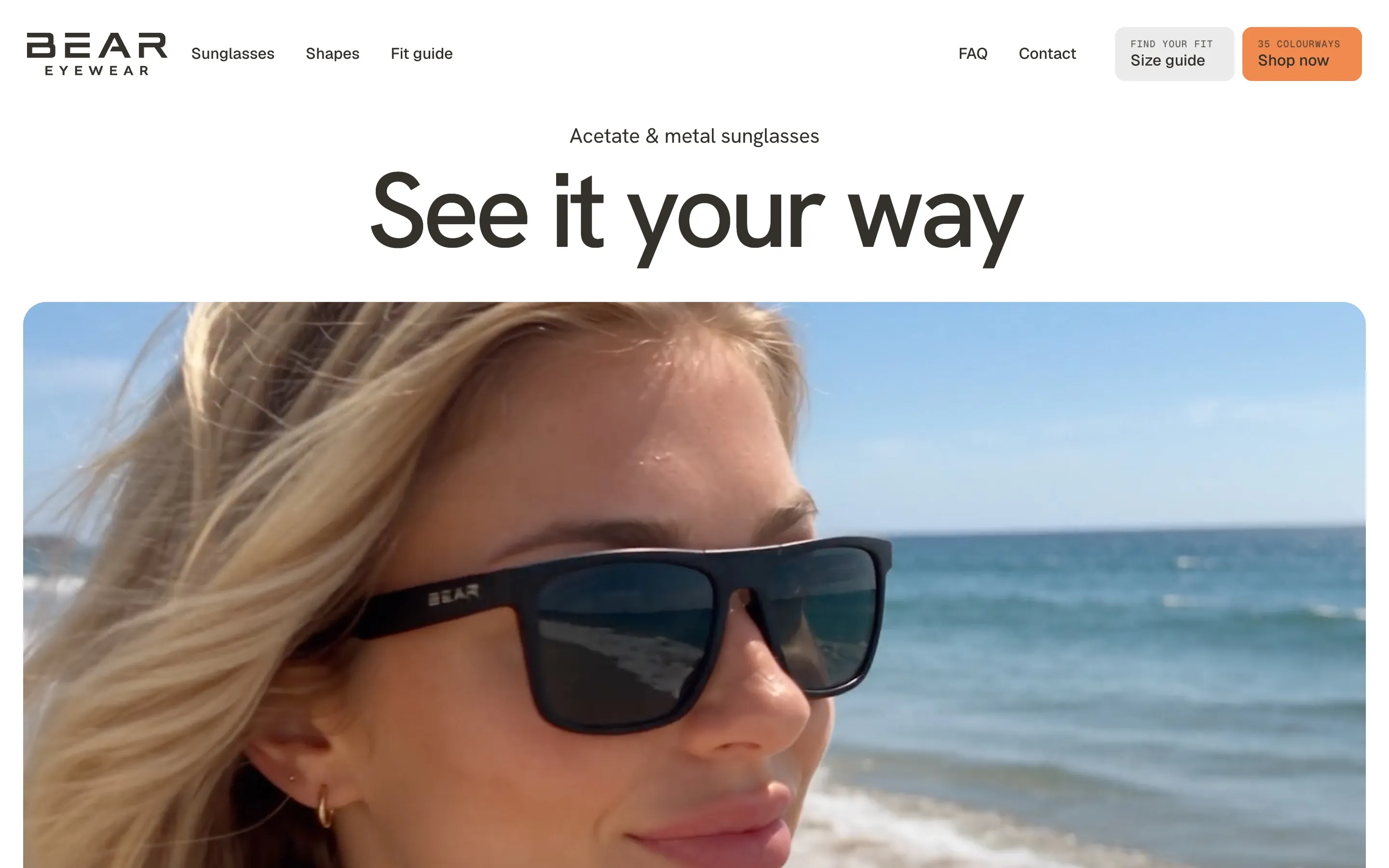 Bear Eyewear homepage with the headline "See it your way" above a large photo of a woman wearing black sunglasses at the beach.
